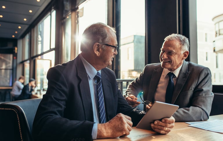 Mature senior advisor and business owner in calm consultation setting