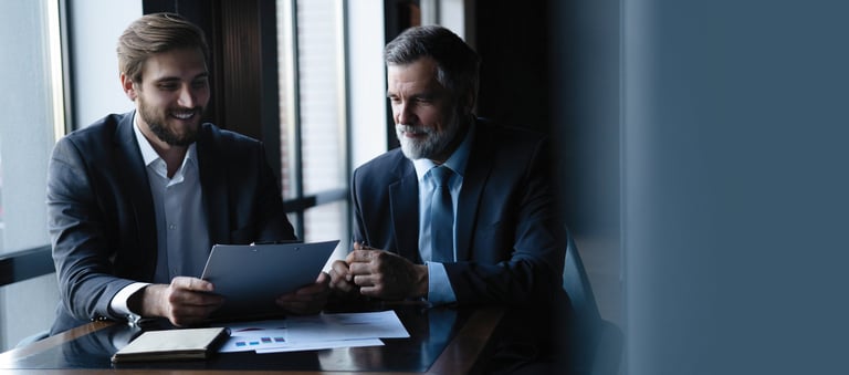 Senior advisor discussing employee benefit options with business leadership
