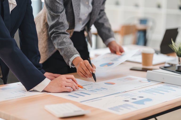 Senior advisor and executive reviewing financial analysis in professional boardroom consultation