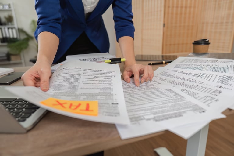 Professional tax advisor reviewing tax credit eligibility documents in modern office