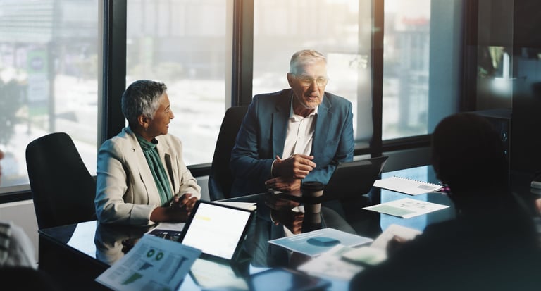 Senior executives reviewing workflow automation opportunity during boardroom meeting