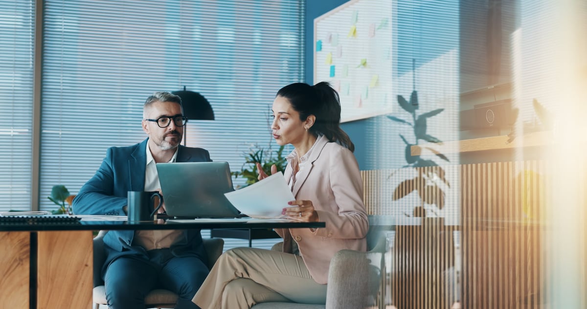 Paperwork, laptop and business people in office with meeting for company investment deal.