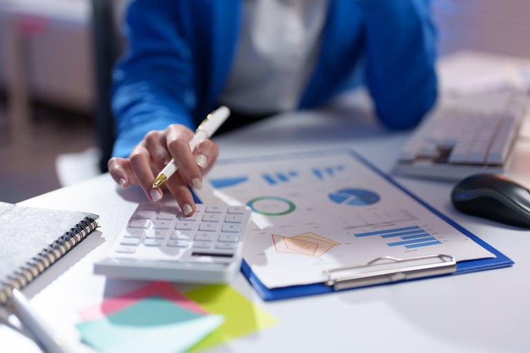 Business professional analyzing financial charts and property tax data