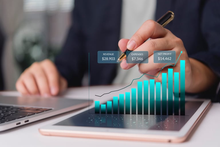 Business analyst reviews revenue expenses profit on tablet for financial report