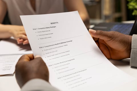 Business owner and senior advisor reviewing employee protection benefit options and coverage plans