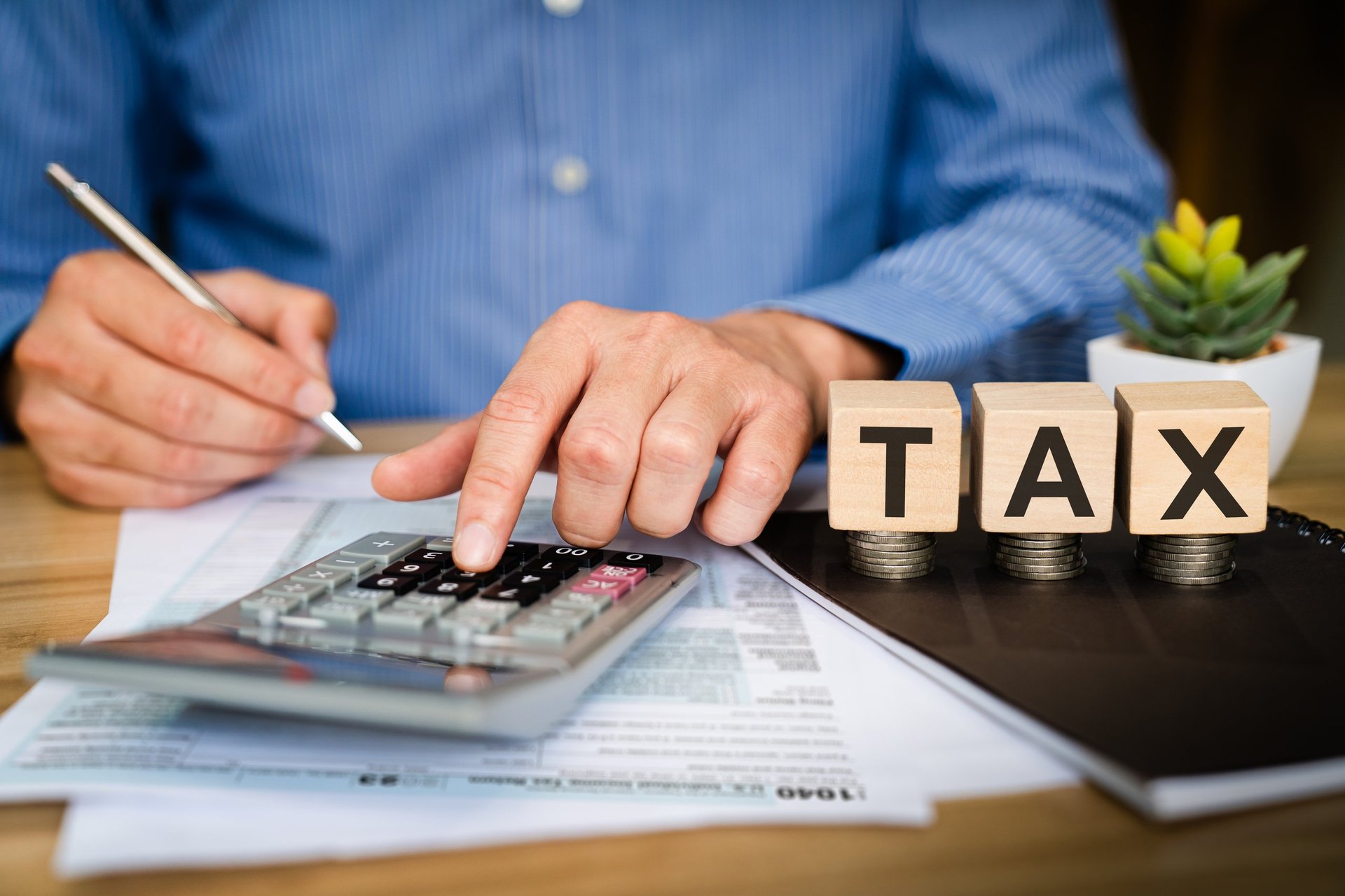 Business professional calculating tax with financial documents and tax planning materials