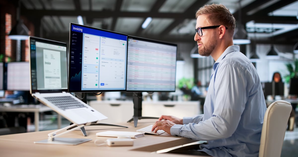 Accounts payable leader reviewing vendor invoices for duplicate payments