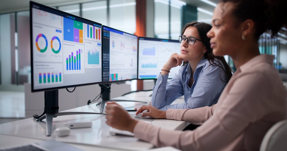 Diverse analytics team reviewing financial data and transaction dashboards in a modern executive office