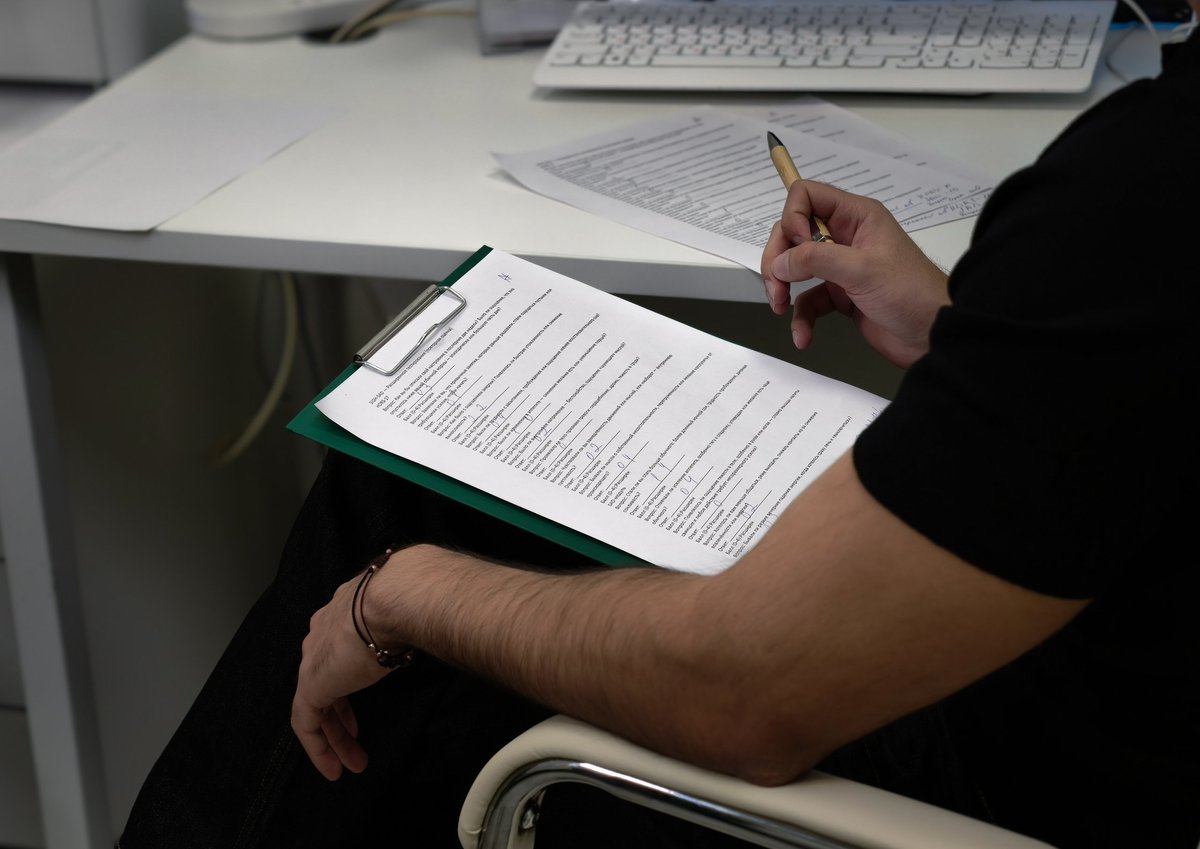 Customs compliance specialist reviewing an import entry form to correct duty errors before and after liquidation