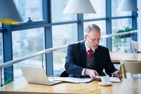 Senior executive and advisor reviewing recovery findings and overpayment documentation