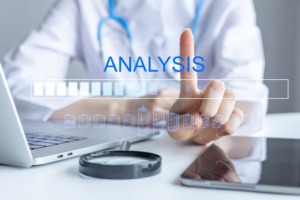 Healthcare professional analyzing data with a magnifying glass, representing employer healthcare cost analysis