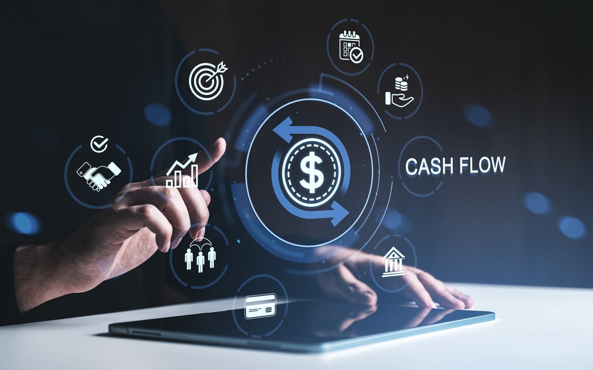 Hand touching digital cash flow icons in glowing modern style on dim background, concept of finance and money management insights