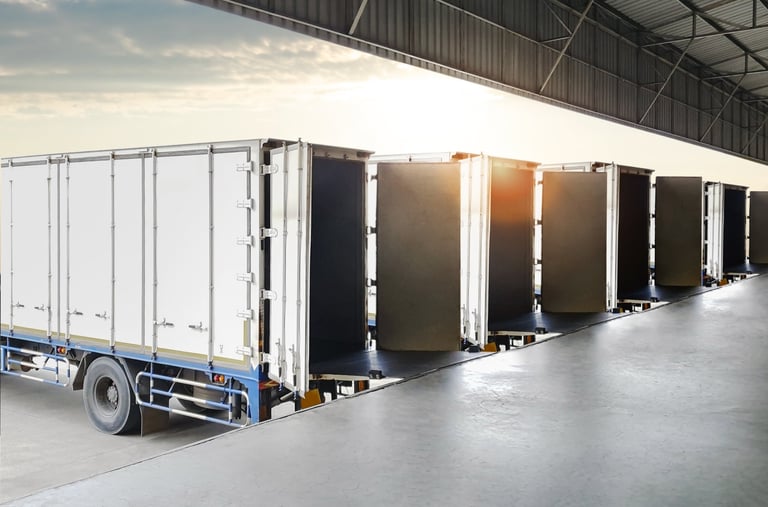 Row of container trucks loading at warehouse distribution center