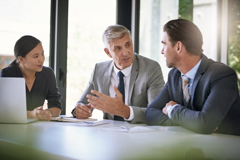 Senior executive team reviewing operating cost data and financial performance in boardroom
