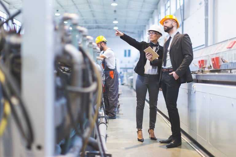 Factory workers on manufacturing floor representing industrial operations cost analysis